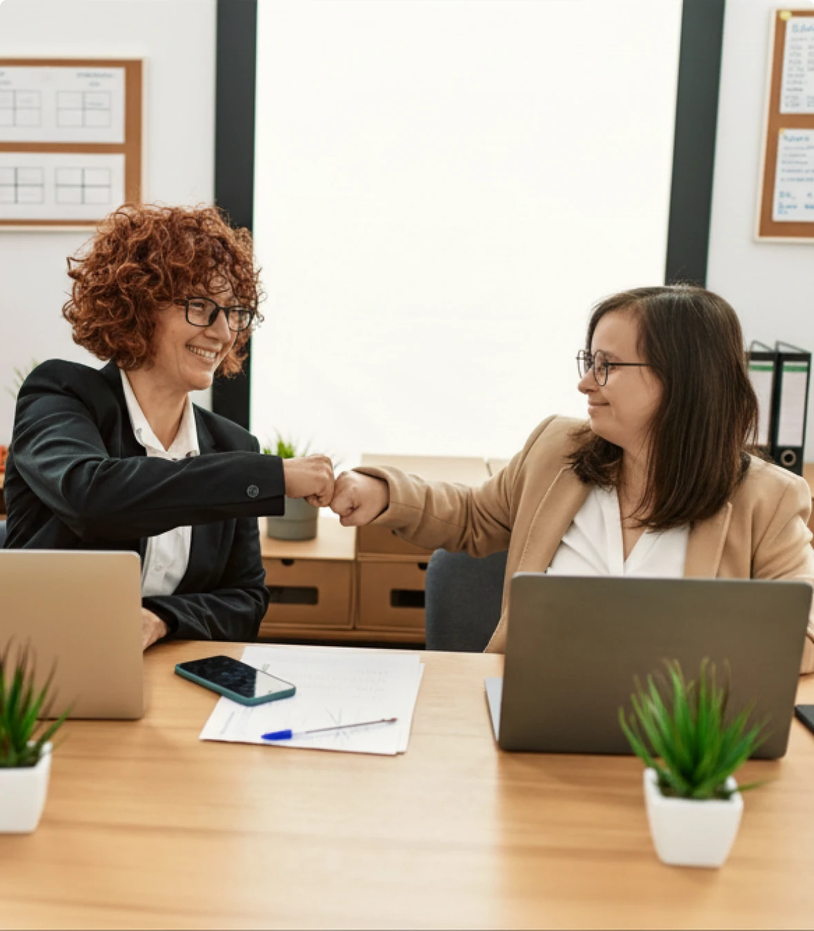 Two women celebrating at work