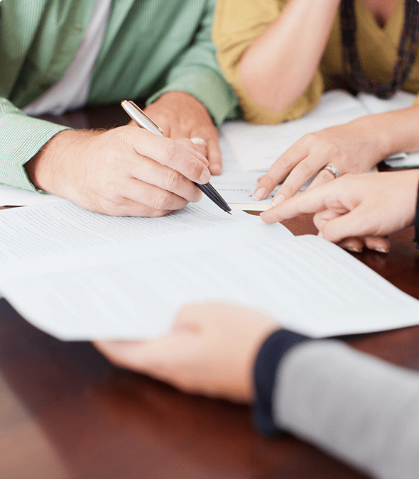 Hands reviewing documents at a meeting