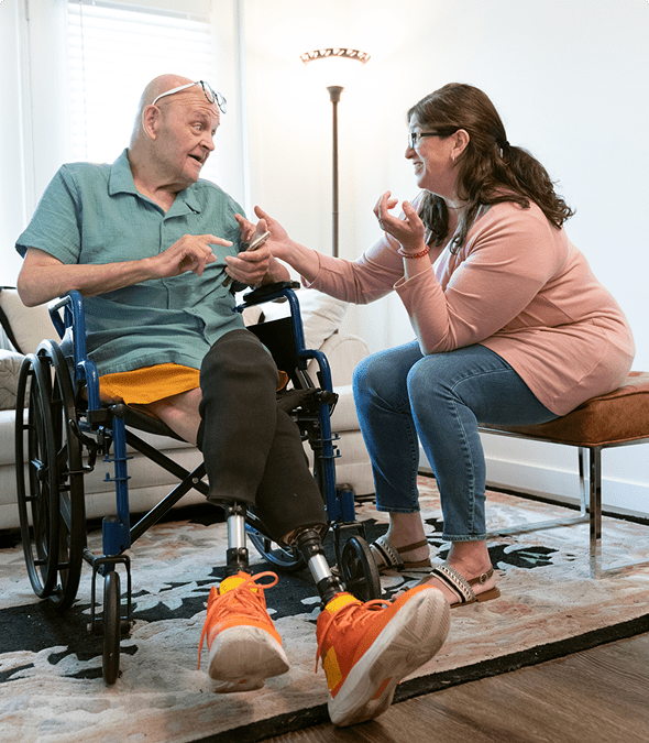 Man in wheelchair talking with woman