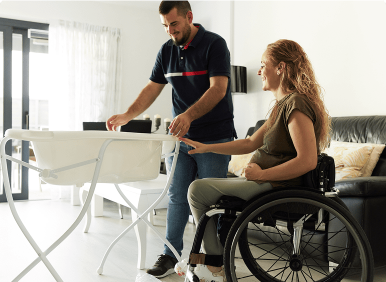 Man and woman setting up baby crib